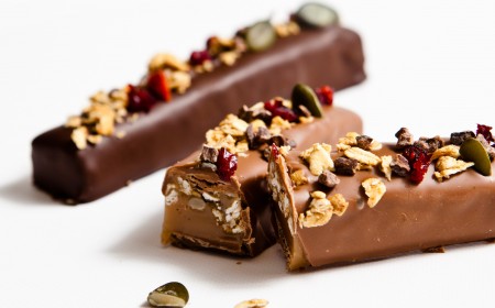 Caramel chocolate bar with healthy fruits and nuts