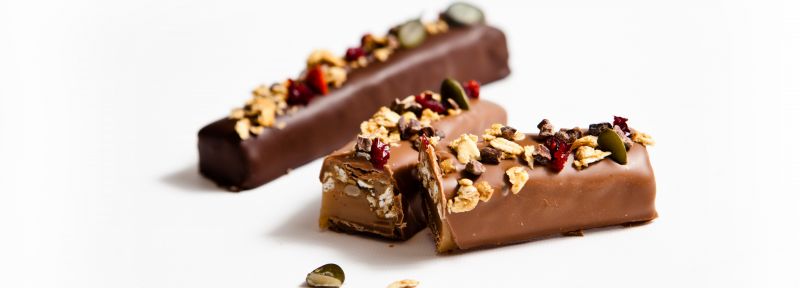 Caramel chocolate bar with healthy fruits and nuts